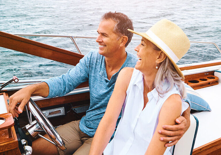 High-net-worth couple on a boat discussing insurance and wealth protection planning