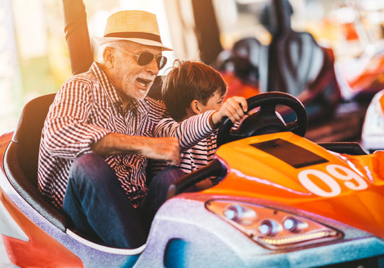 Grandfather and grandson enjoying an amusement park