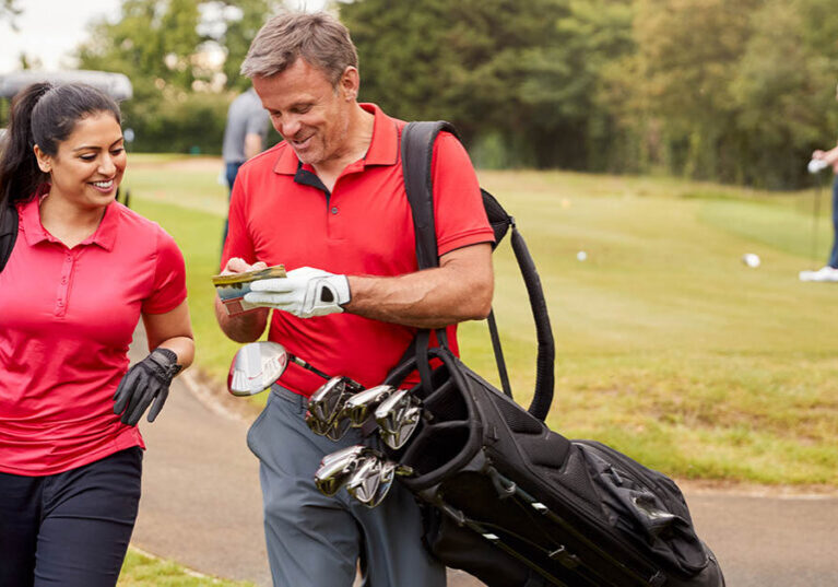 Financially Independent Couple Playing a Round of Golf