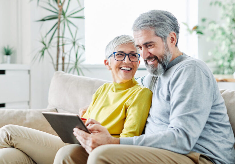 happy senior couple discusses charitable giving