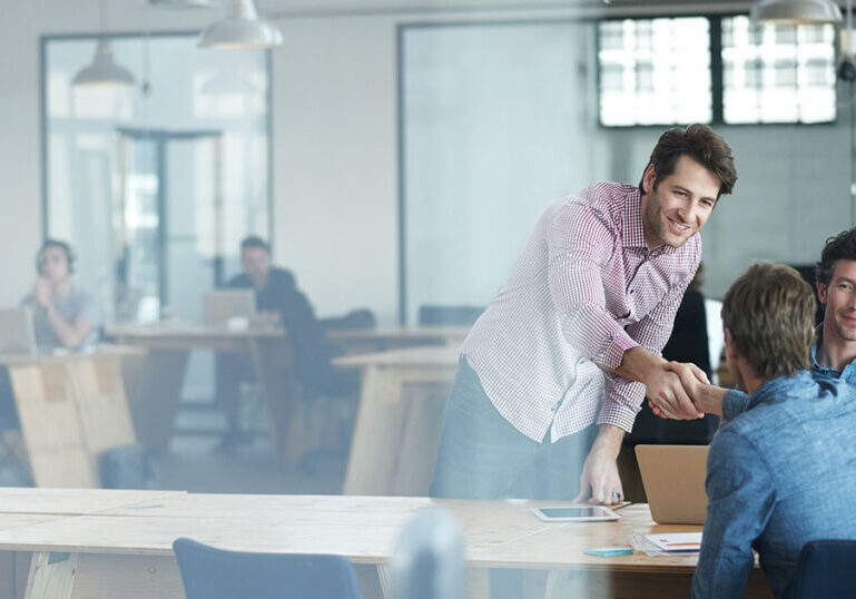 Sales team closing deal with another business using education-based selling