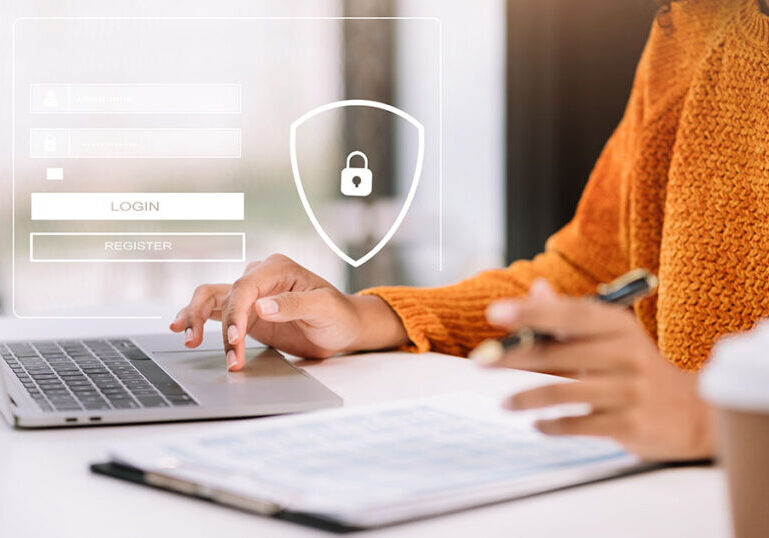 Employee practicing cybersecurity training by using a strong password to lock her work computer