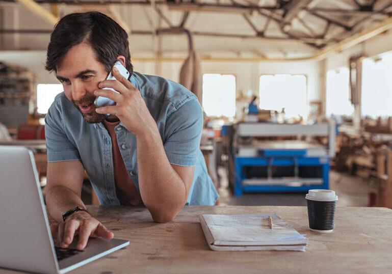 Business owner looking over taxes in warehouse