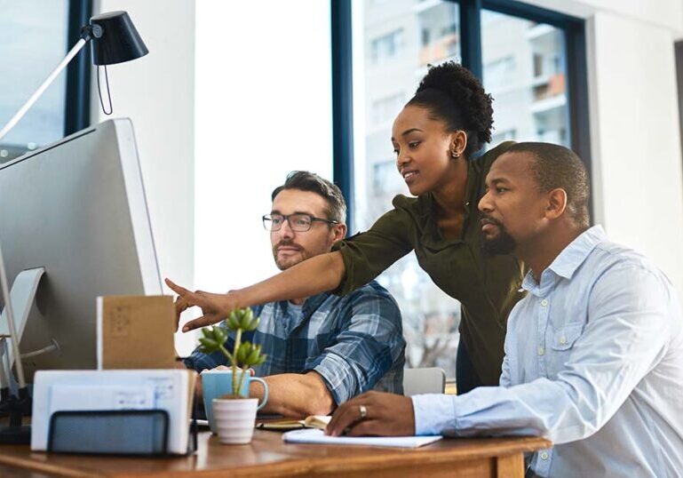 team members discussing ERP upgrade in office