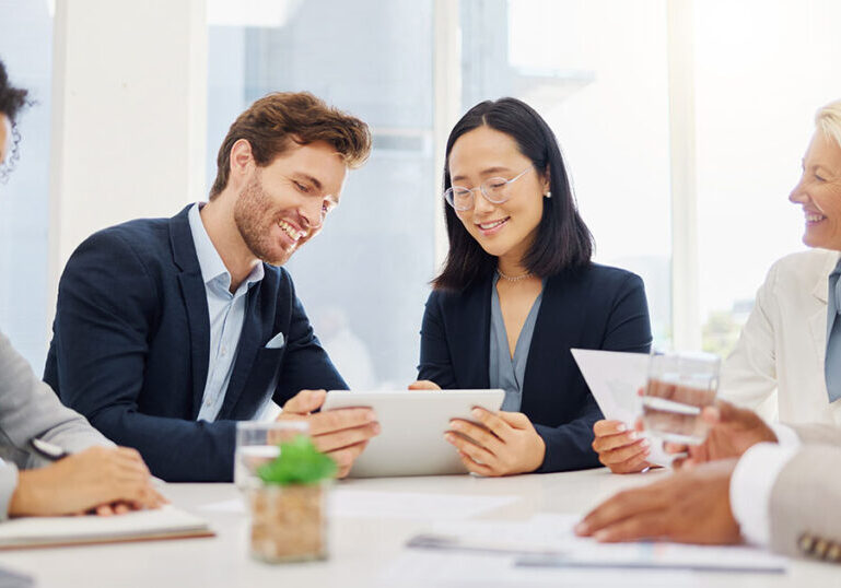 human capital management team reviewing tablet for metrics