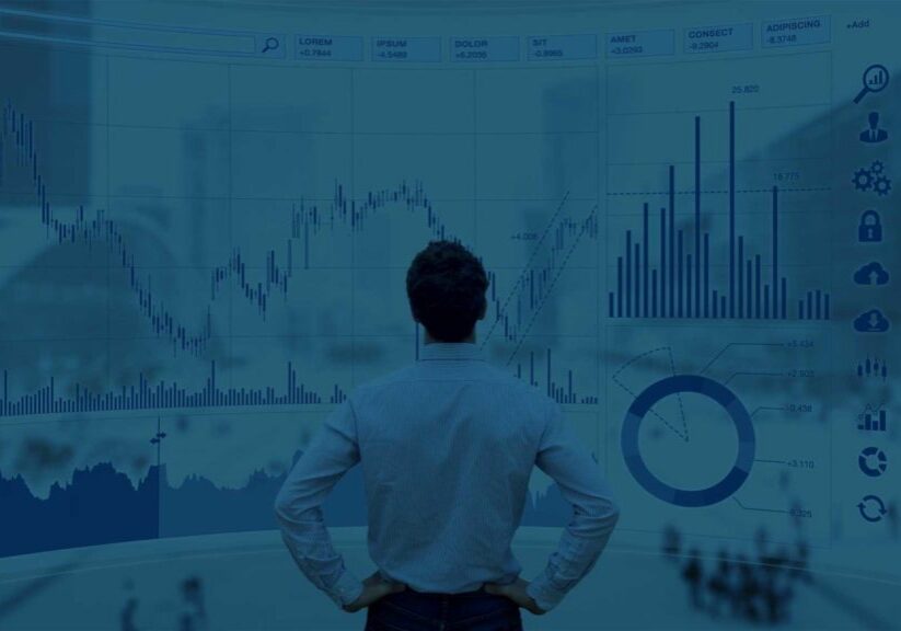 Man reviewing large screen of charts