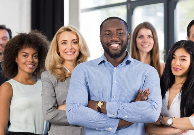 group of employees smiling at office space