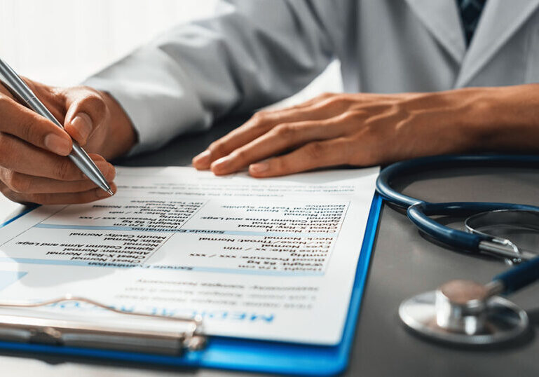 Doctor writing note for employee sick leave